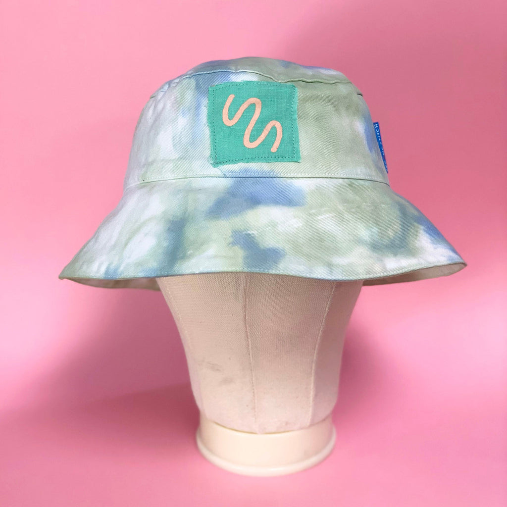 Blue Tie Dyed Bucket Hat with green label